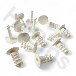 May include: A collection of off-white plastic wall anchors. The anchors have a round head and a ribbed body designed for secure fastening in drywall. The image shows several anchors scattered against a white background, highlighting their design.