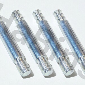 May include: Four silver-colored furniture dowel screws. Each screw has a threaded end, a smooth central shaft, and a grooved top. The dowels are arranged diagonally against a white background.