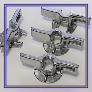 May include: A collection of silver-colored wing nuts, designed for secure fastening. Each nut features a central threaded hole and two wing-shaped extensions for easy tightening by hand. The nuts are made of a durable metal.