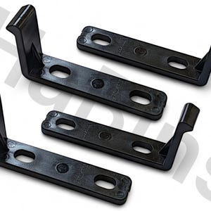 May include: Four black plastic L-shaped brackets. Each bracket has a rectangular base with two oval holes and a rounded end. The vertical arm has a curved top. The brackets are designed for structural support.
