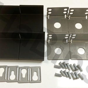 May include: A hardware kit featuring black corner brackets, metal mounting plates with keyhole slots, and silver screws. The kit also includes silver metal hinge plates. Ideal for furniture assembly or repair.