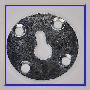 May include: A silver-colored metal picture hanger with a keyhole slot and four screw holes. The hanger is circular with a slightly textured surface and a white keyhole insert.