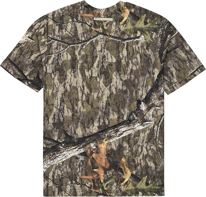 May include: A short-sleeved camouflage t-shirt featuring a realistic forest pattern in shades of brown, green, and tan. The shirt has a crew neck and a standard fit. The text "DEAR UP SOUTHERN" is visible on the shirt.