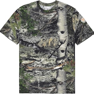May include: A camouflage-patterned t-shirt with short sleeves, displaying a blend of green, brown, and grey hues, resembling a woodland scene. The shirt has a crew neck and a small logo patch on the sleeve.