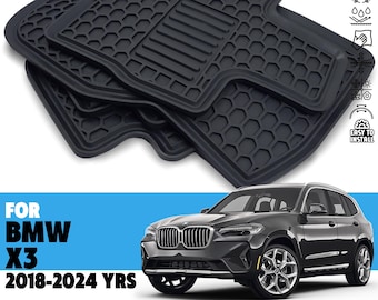 May include: Black rubber floor mats for a BMW X3 (2018-2024). The mats have a textured surface with a honeycomb and grooved pattern. The image also shows a black BMW X3.