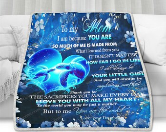 May include: A blue and white fleece blanket with a heart-shaped design featuring two sea turtles. The blanket has a message that reads "To my Mom I am because you are so much of me is made from what I learned from you It doesn't matter how far I go in life I will always be your little girl And you will always be my loving mother Thank you for the sacrifices you make every day I love you with all my heart To the world you may be just a mother But to me you are the world Love, your Daughter"