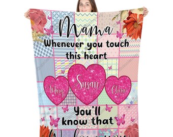 May include: A pink and white patchwork fleece blanket with a message that reads "Mama Whenever you touch this heart You'll know that We love you". Three pink hearts with the names "Susan", "Jitary", and "Clara" are in the center of the blanket.