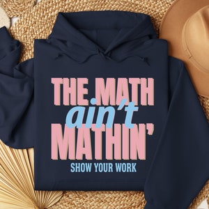 May include: Navy blue hoodie with the text "THE MATH ain't MATHIN' SHOW YOUR WORK" in pink and blue lettering.