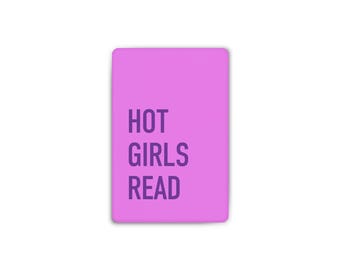 May include: A rectangular pink sign featuring the dark purple text HOT GIRLS READ centered on the front. The sign has rounded corners and a smooth, flat surface with a solid color background, displaying the text in a clean, sans-serif font.