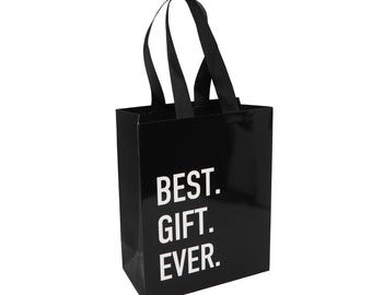 May include: A glossy black gift bag with two black fabric handles. The front of the bag features the white text BEST. GIFT. EVER. printed in a bold, sans-serif font. The bag has a rectangular shape with a smooth, reflective surface finish.