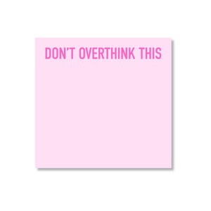 May include: A square light pink sticky note featuring the text DON'T OVERTHINK THIS printed in a bold, sans-serif hot pink font across the top portion of the paper. The note has a smooth, matte finish and a clean, uniform square shape.