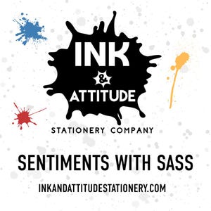 The image is a promotional graphic for a stationary company called "Ink & Attitude Stationery Company". It features a splash of ink splatters and the company's name in bold, black text. The company's slogan "Sentiments with Sass" is also displayed in the image.