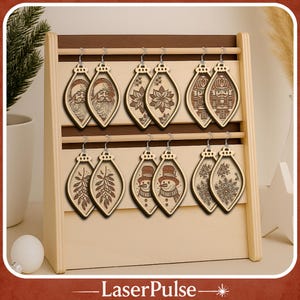 May include: Wooden Christmas ornament earrings displayed on a wooden stand. The earrings feature various holiday designs, including Santa Claus, poinsettias, nutcrackers, snowmen, and snowflakes. The earrings are light brown with darker brown etched details.
