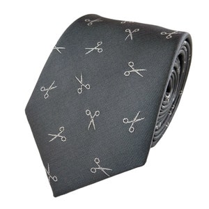 May include: A gray silk tie with a white repeating pattern of scissors.