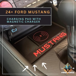May include: Black charging pad with red "MUSTANG" lettering and a wireless charging symbol. Designed for a 24+ Ford Mustang, it includes a magnetic charger. A USB port is also visible in the image.