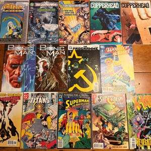 May include: A collection of vintage comic books, featuring titles like "Elric", "Bionic Man", "Copperhead", "Wonder Girl", "Superman", and "X-Men". The covers display colorful illustrations and text.