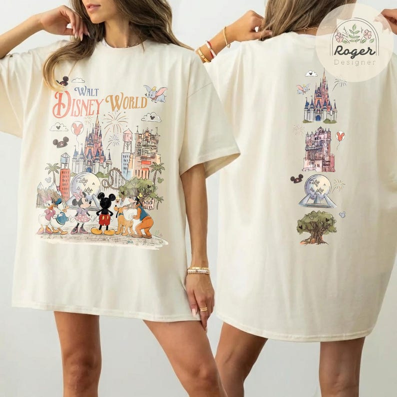 May include: An off-white t-shirt featuring a Walt Disney World graphic on the front with Mickey Mouse, Minnie Mouse, Donald Duck, and Pluto in front of the castle. The back displays a vertical arrangement of park icons including the castle.