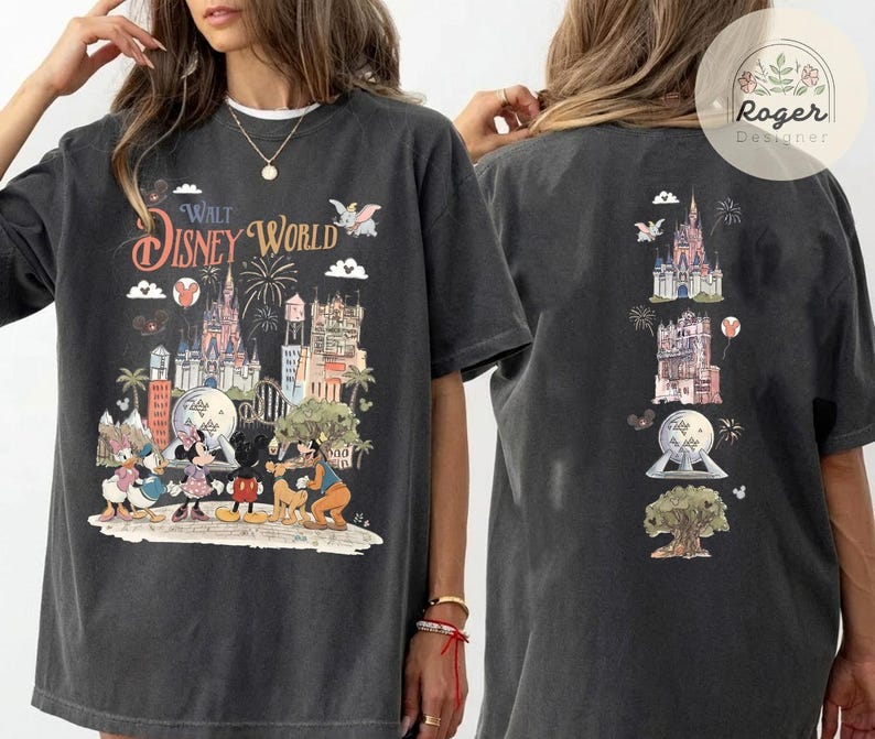 May include: A charcoal gray oversized t-shirt featuring a front graphic of Walt Disney World with Mickey Mouse, Minnie Mouse, Donald Duck, Daisy Duck, and Goofy. The back displays a vertical arrangement of park icons including the castle.