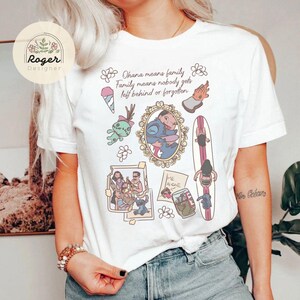 K&ouml;nnte beinhalten: Wei&szlig;es T-Shirt mit farbenfrohem Aufdruck. Das Design enth&auml;lt den Text "Ohana means family. Family means nobody gets left behind or forgotten" und Illustrationen von Charakteren und Szenen.