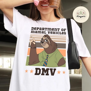 May include: White t-shirt featuring a cartoon sloth character in a green shirt and tie, with the text "DEPARTMENT OF MAMAL VEHICLES" and "DMV". The sloth is pointing upwards against a striped background.