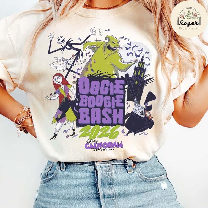 May include: A cream-colored t-shirt featuring a graphic print of characters from The Nightmare Before Christmas, including Oogie Boogie, Sally, and Jack Skellington. The text reads OOGIE BOOGIE BASH 2026 DISNEY CALIFORNIA ADVENTURE.