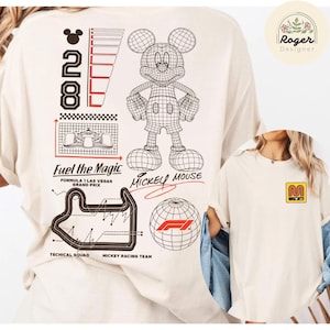 May include: Cream-colored t-shirt featuring a wireframe Mickey Mouse graphic, the text "Fuel the Magic," and a Formula 1 Las Vegas Grand Prix design. The shirt also has the text "Mickey Mouse" and the number "28."