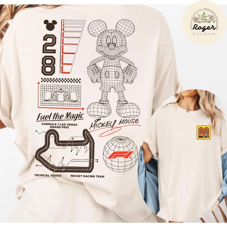 May include: Cream-colored t-shirt featuring a wireframe Mickey Mouse graphic, the text "Fuel the Magic," and a Formula 1 Las Vegas Grand Prix design. The shirt also has the text "Mickey Mouse" and the number "28."