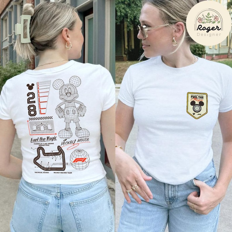 May include: White t-shirt with a Mickey Mouse graphic on the back and a small emblem on the front. The back graphic includes the number 28, a Mickey Mouse outline, and the text "Fuel the Magic". The front emblem says "Fuel the Magic".