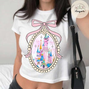 Coquette bow Disneyland castle Baby tee, Watercolor castle Disneyland Girls trip Croptop Baby Tee womens T-shirt, California adventure shirt