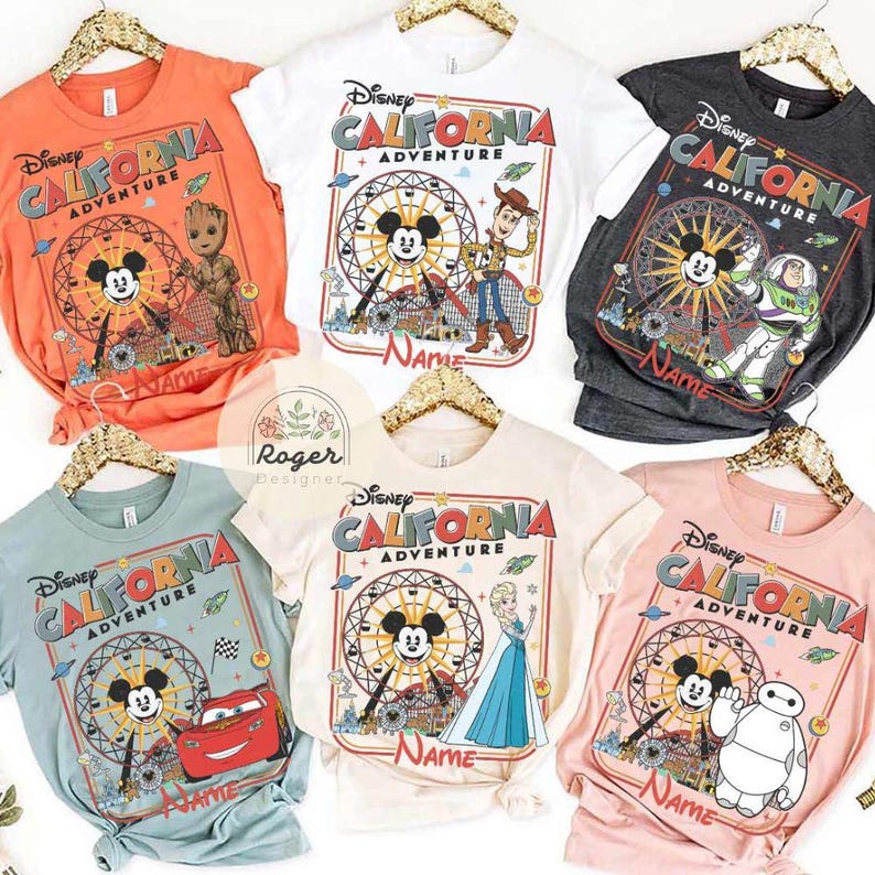 May include: A collection of Disney California Adventure t-shirts in various colors, including orange, white, gray, light blue, beige, and pink. Each shirt features a Ferris wheel design with different Disney characters and the text "Disney California Adventure" and "Name".
