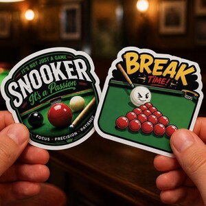May include: Two die-cut vinyl stickers featuring snooker themes. The left sticker shows a snooker table with balls and the text 'IT'S NOT JUST A GAME SNOOKER It's a Passion FOCUS PRECISION PATIENCE'. The right sticker shows a winking cue ball and red balls with the text 'BREAK TIME!'.