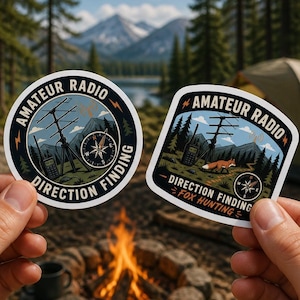 May include: Two circular and shield-shaped vinyl stickers featuring Amateur Radio Direction Finding graphics. The designs include a radio antenna tower, a handheld radio, a compass, and a fox, with the text Amateur Radio Direction Finding.