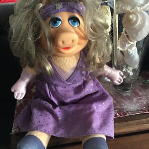 Adorable Miss Piggy in a dress with golden locks purple dress