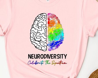 May include: Pink t-shirt with a rainbow brain graphic and the text "Neurodiversity Celebrate The Spectrum".