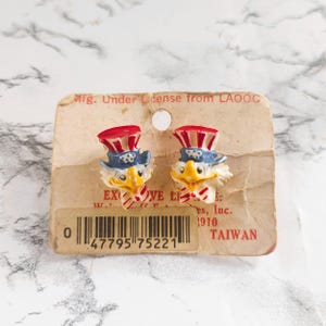Recuerdo Olímpico de 1984: Pendientes 3D de Sam el Águila (Tarjeta original)