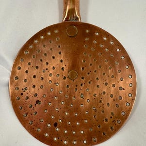 Colador de espumadera antiguo francés de cobre con mango de madera.