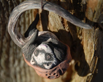 Sleeping ferret walnut ornament