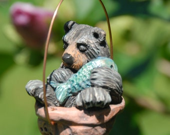 Sleeping black bear walnut ornament