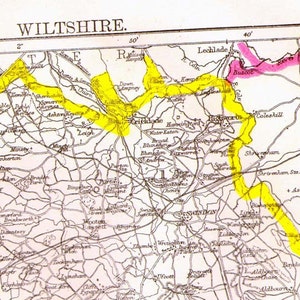 May include: A vintage map of Wiltshire, England, with highlighted areas in yellow and pink. The map shows towns, rivers, and roads. The text "WILTSHIRE" is at the top of the map.
