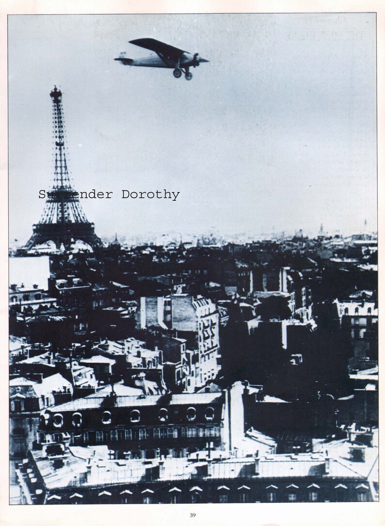 May include: A black and white photograph of the Eiffel Tower in Paris, France. A small airplane flies over the tower. The text "Swender Dorothy" is printed on the image.
