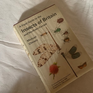 May include: A field guide to the insects of Britain and Northern Europe by Michael Chinery. The book cover features illustrations of various insects, including a dragonfly, a beetle, and a butterfly. The book has over 1000 illustrations, 778 in color.