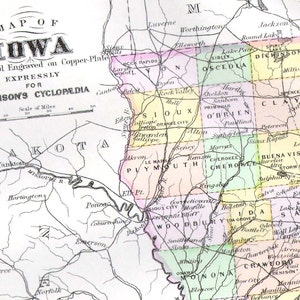 May include: A vintage map of Iowa, showing the state's counties and major cities. The map is printed in black and white with colored borders for each county. The map is titled "Map of Iowa" and includes a scale of miles.