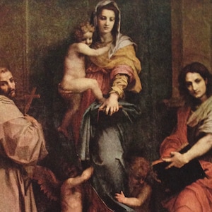 May include: A classical painting depicting a religious scene. The central figure, a woman in a yellow and blue robe, holds a child. Other figures include a man in a brown robe holding a cross and another woman in a red robe holding a book. The artwork has a warm color palette.