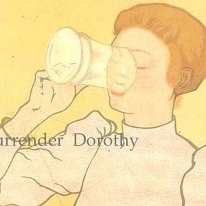 May include: A woman with red hair is drinking from a white cup. The text "Surrender Dorothy" is printed on the image.