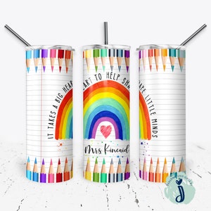 May include: Three stainless steel tumblers with colorful rainbow and pencil designs. The tumblers have the text "It takes a big heart", "Art to help shape", and "Shape little minds". One tumbler has the name "Mrs. Kincaid" written on it.