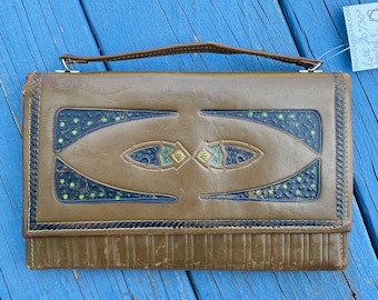 May include: A brown leather clutch purse with a geometric design featuring green, blue, and gold accents. The purse has a top handle and a flap closure.