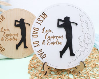 May include: Two wooden signs with a golfer silhouette and the text "Best Dad By Par" and "Love, Cameron & Emelia".
