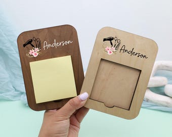 May include: Two wooden memo holders, one dark brown and one light brown, with rounded corners. Each features a floral design with a hairdryer and scissors, the name "Anderson", and a space for notes or a photo. The dark brown holder has a yellow sticky note.