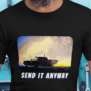 May include: Black t-shirt with a graphic of a red car driving through a cloud of dust. The text "SEND IT ANYWAY" is printed below the image.
