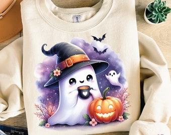 May include: A cream colored sweatshirt with a cute cartoon ghost wearing a witch's hat and holding a cup of coffee. The ghost is sitting next to a jack-o-lantern pumpkin. The background is a purple and blue watercolor design with stars and bats.
